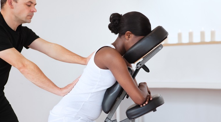 a woman being treated in a massage chair