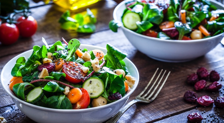 two scrumptious salads on a farm-style table