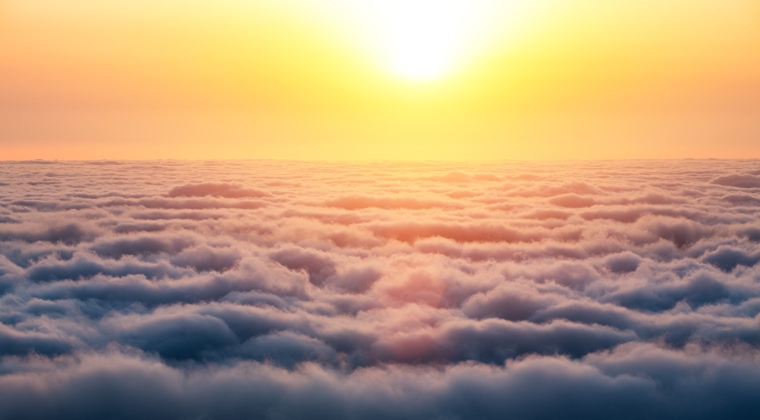 the sun over cumulus clouds