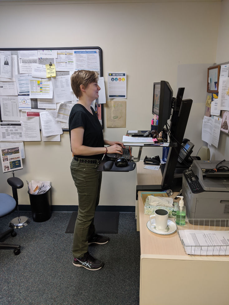 female standing at desk